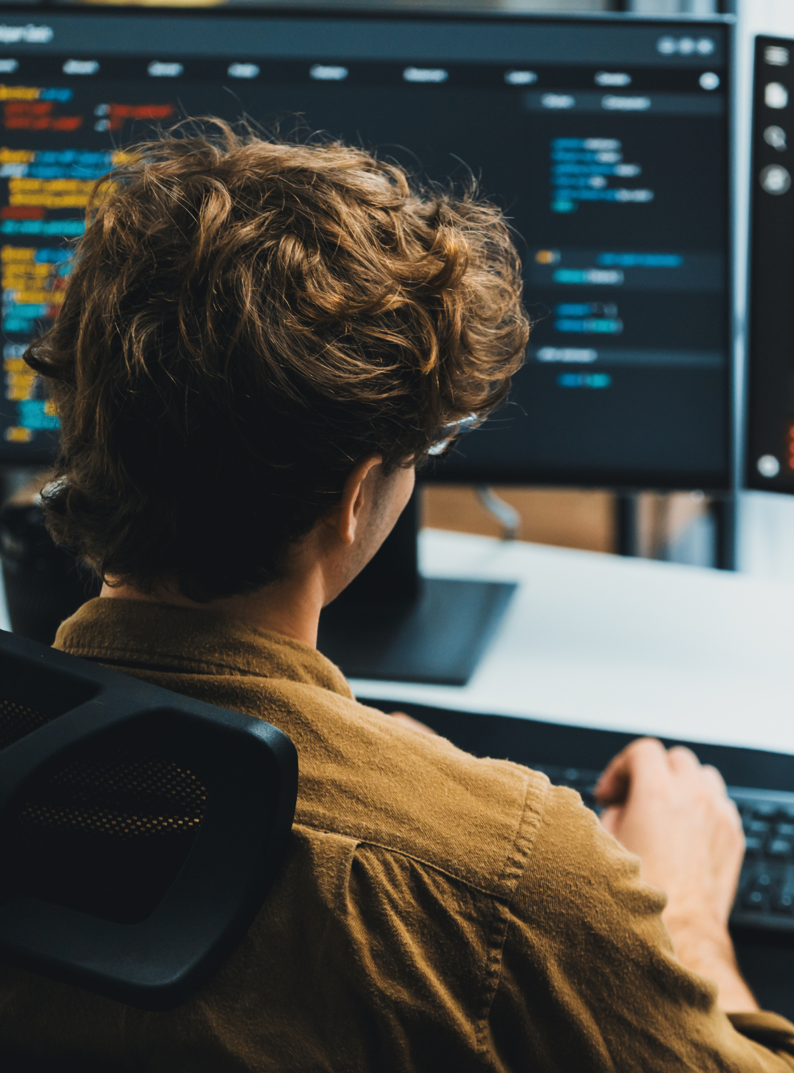 Tech professional working at a desktop computer.