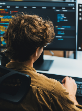 Tech professional working at a desktop computer.