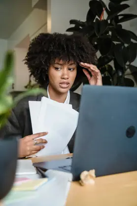 A concerned university graduate using a laptop.