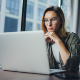Tech professional reading off a laptop screen.