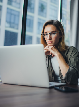 Tech professional reading off a laptop screen.