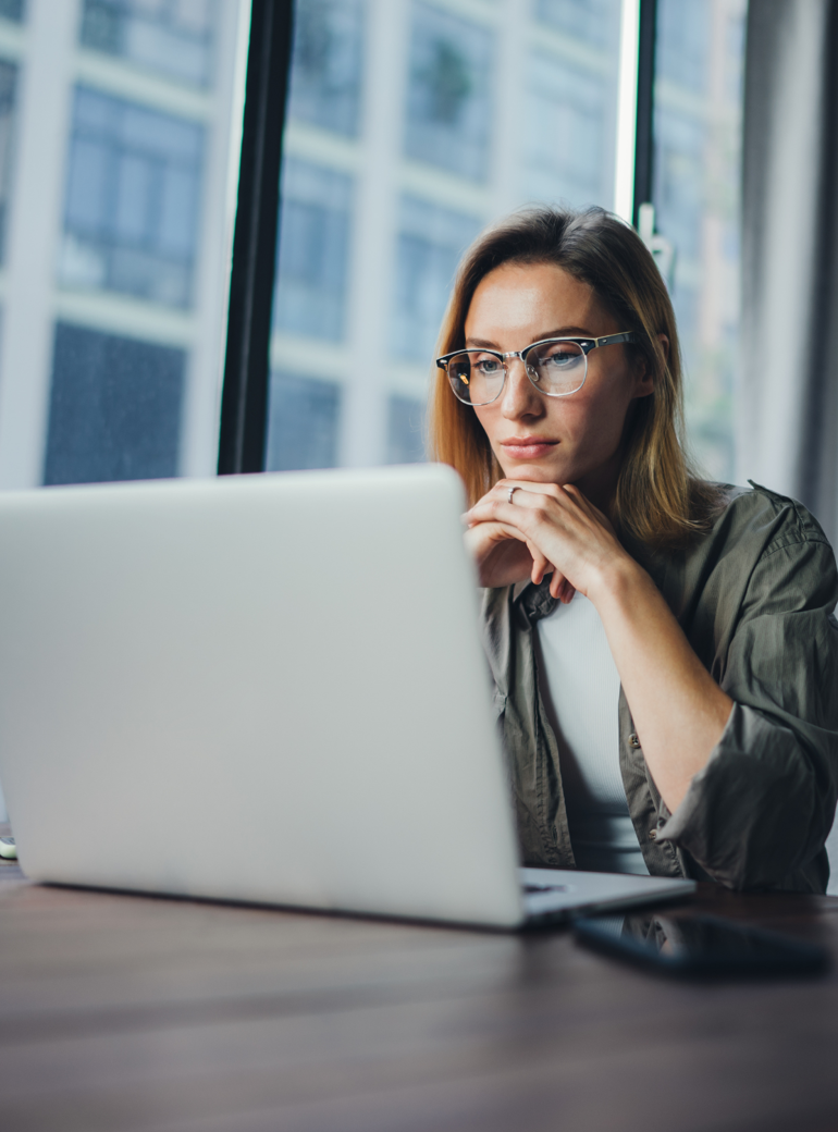 Tech professional reading off a laptop screen.