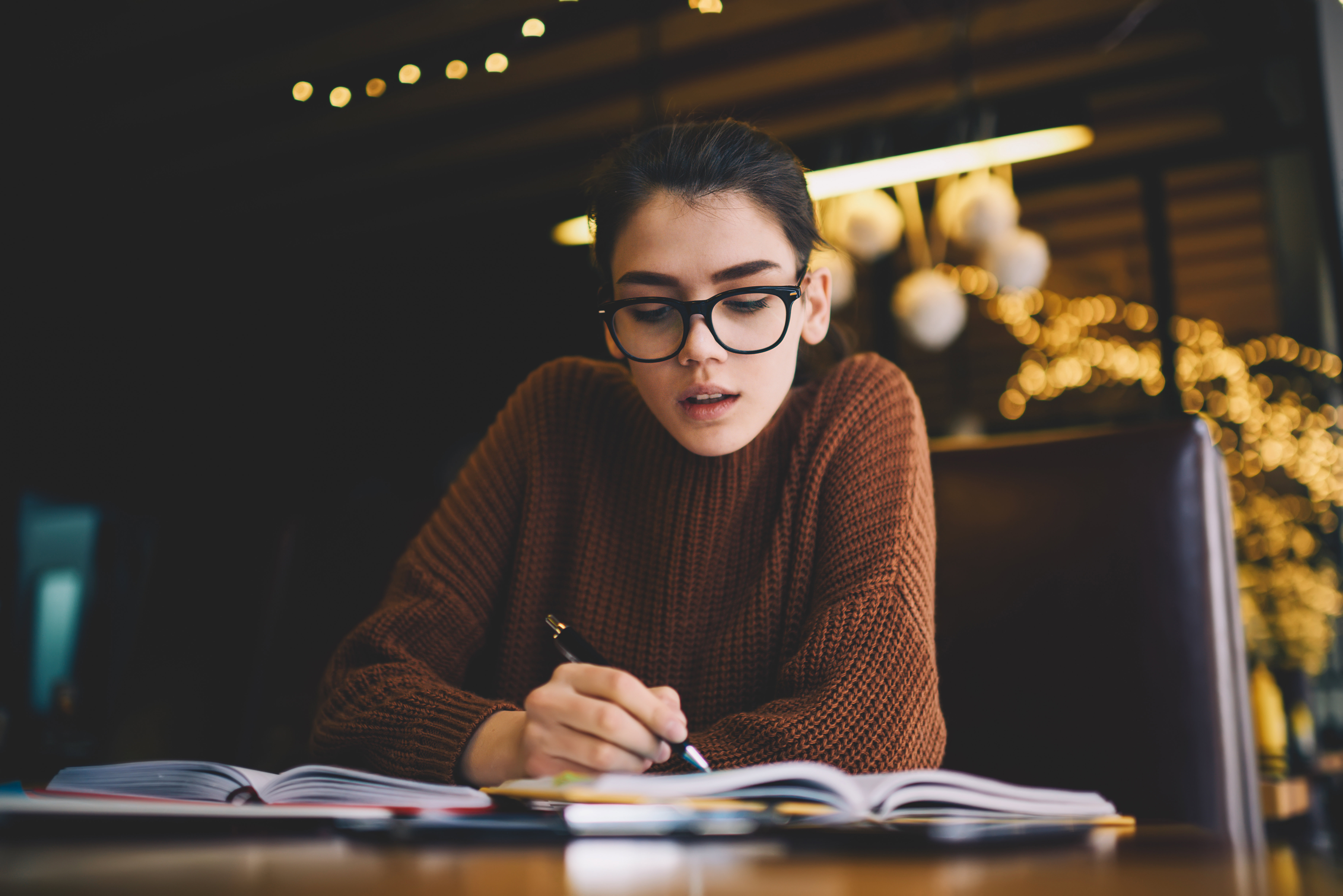 A young person studying at a desk. 