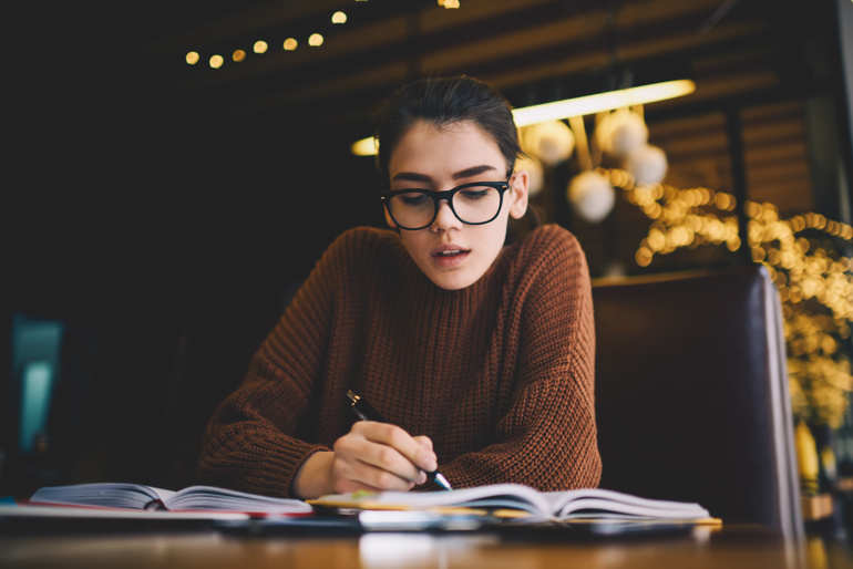A young person studying at a desk. 