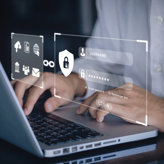 A person types on a laptop with digital login interface graphics displaying username and password fields, security icons, and a login button, symbolizing online account security.