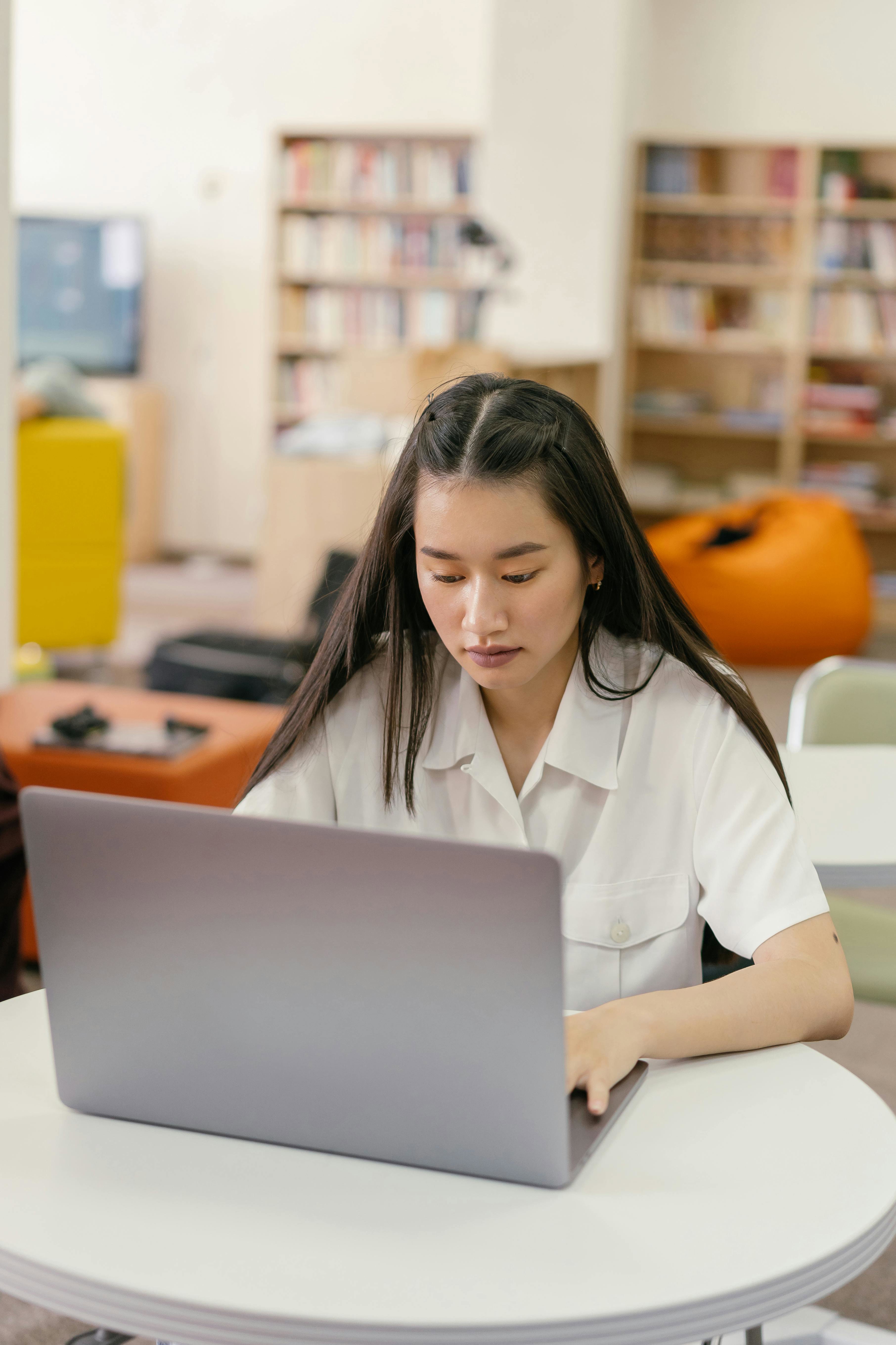 A Business Analyst working on a laptop at a desk. 