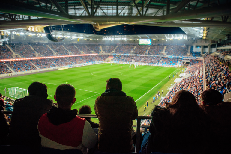 View inside a football stadium, mid match.