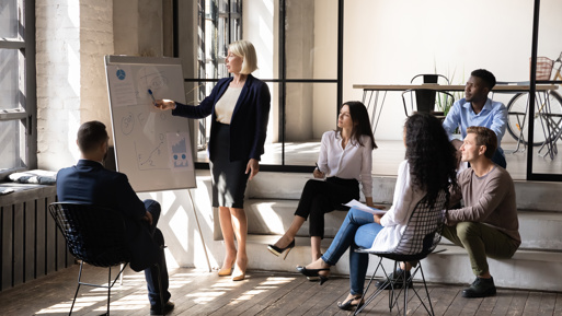 A 40-year-old businesswoman giving a presentation in an office.