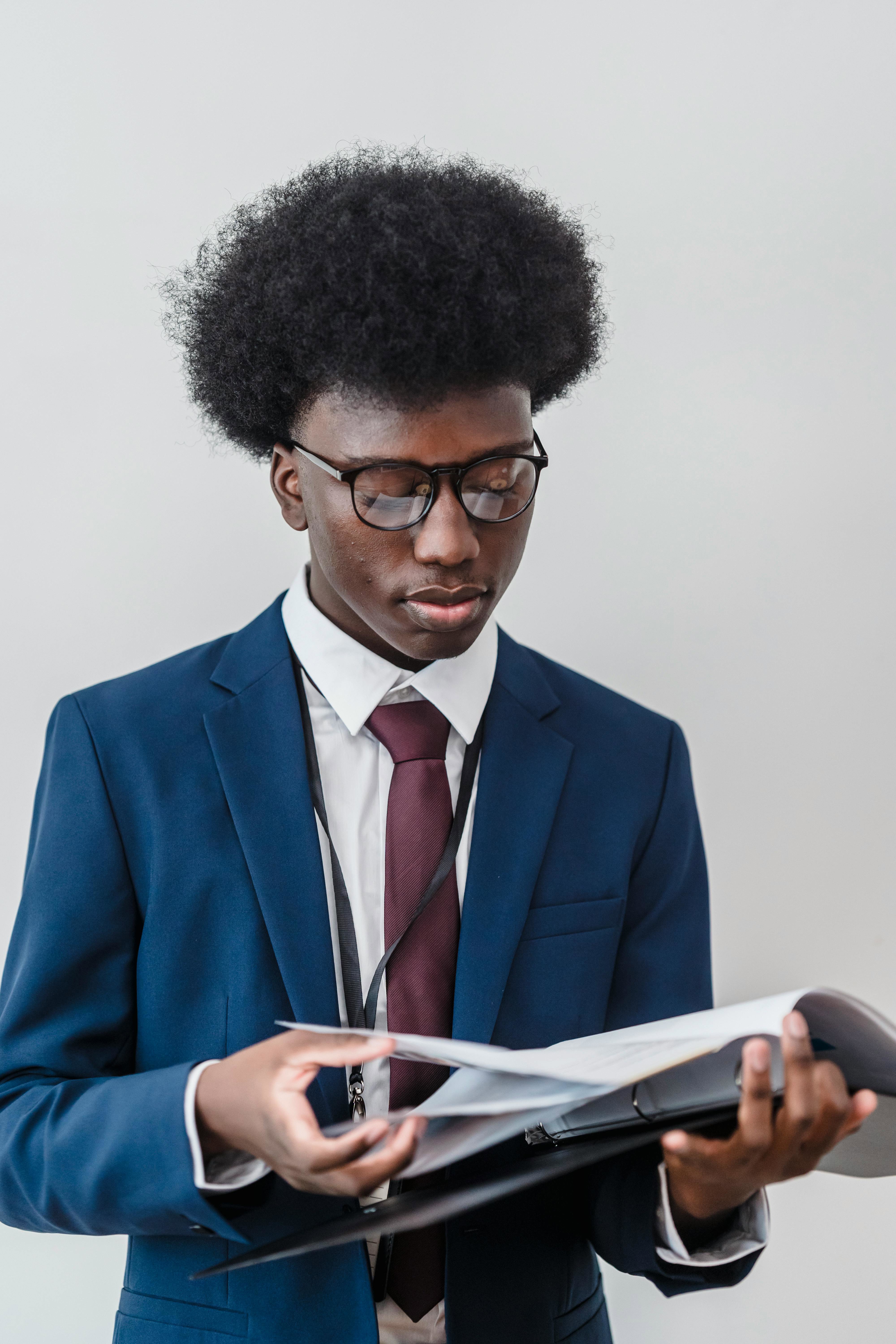 A Business Analyst looking through a physical file of documents. 