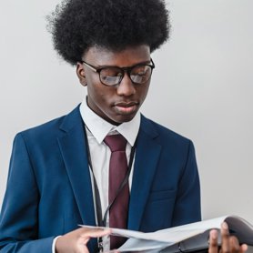 A Business Analyst looking through a physical file of documents.